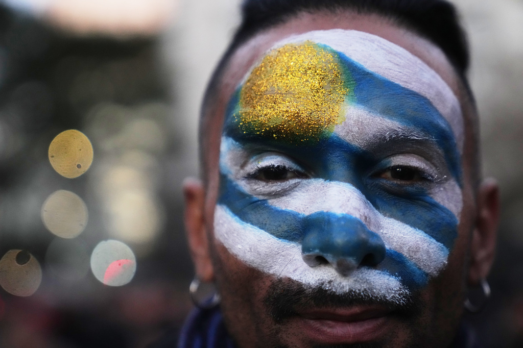 FILE - A fan, his face painted with The Uruguayan team's national colors, attends a watch party for the World Cup soccer match against Saudi Arabia, in Montevideo, Uruguay June 15, 2026. (AP Photo/Matilde Campodonico, File)