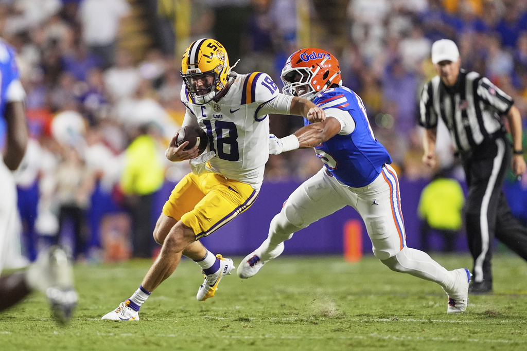 LSU quarterback Garrett Nussmeier (18) carries against Florida Jaiden Braker in the first half of an NCAA college football game, Saturday, Sept. 13, 2025, in Baton Rouge, La. (AP Photo/Gerald Herbert)