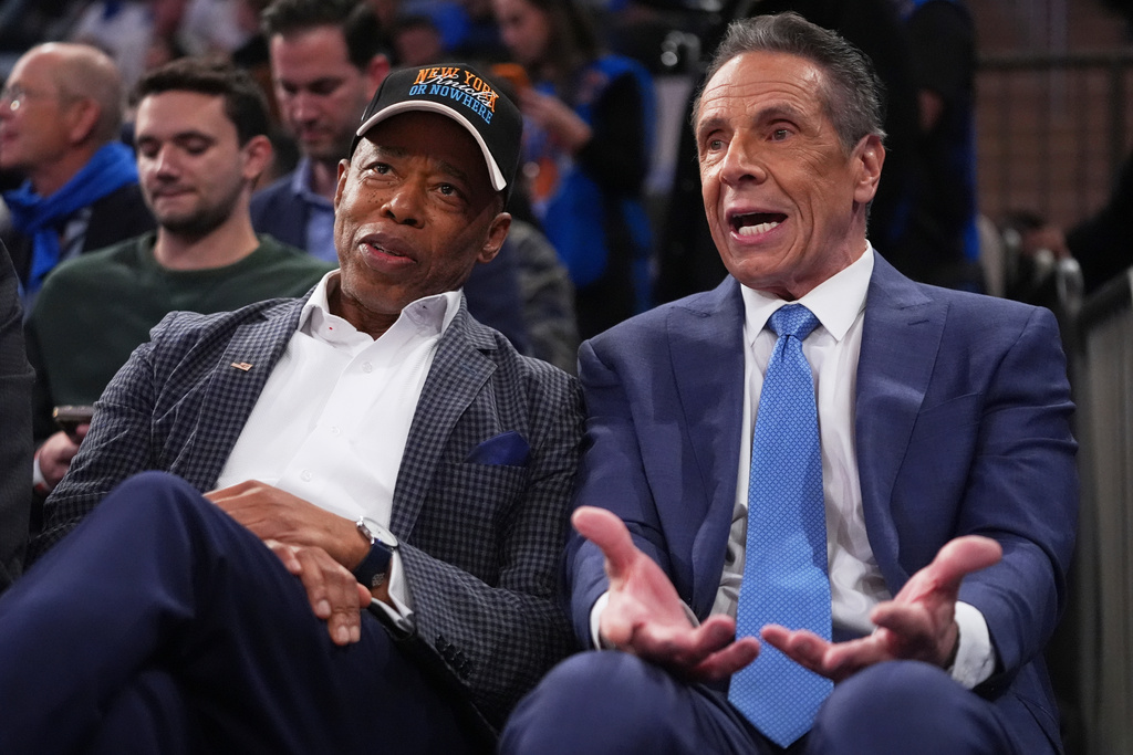 New York City Mayor Eric Adams and Independent candidate former New York Gov. Andrew Cuomo, right, speak during the second half of an NBA basketball game between the New York Knicks and the Cleveland Cavaliers Wednesday, Oct. 22, 2025, at Madison Square Garden in New York. (AP Photo/Frank Franklin II)