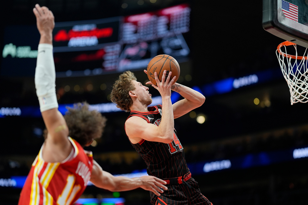Chicago Bulls forward Matas Buzelis (14) drives past Atlanta Hawks guard Trae Young (11) during the first half of an NBA basketball game, Tuesday, Dec. 23, 2025, in Atlanta. (AP Photo/Mike Stewart)