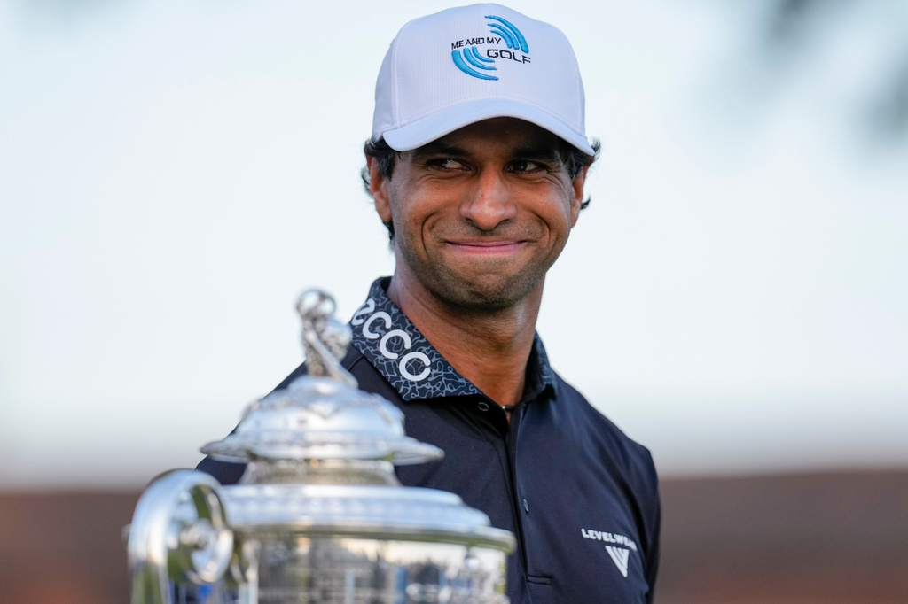 Aaron Rai, of England, looks past the Wanamaker Trophy after winning the PGA Championship golf tournament at Aronimink Golf Club, Sunday, May 17, 2026, in Newtown Square, PA. (AP Photo/Carolyn Kaster)