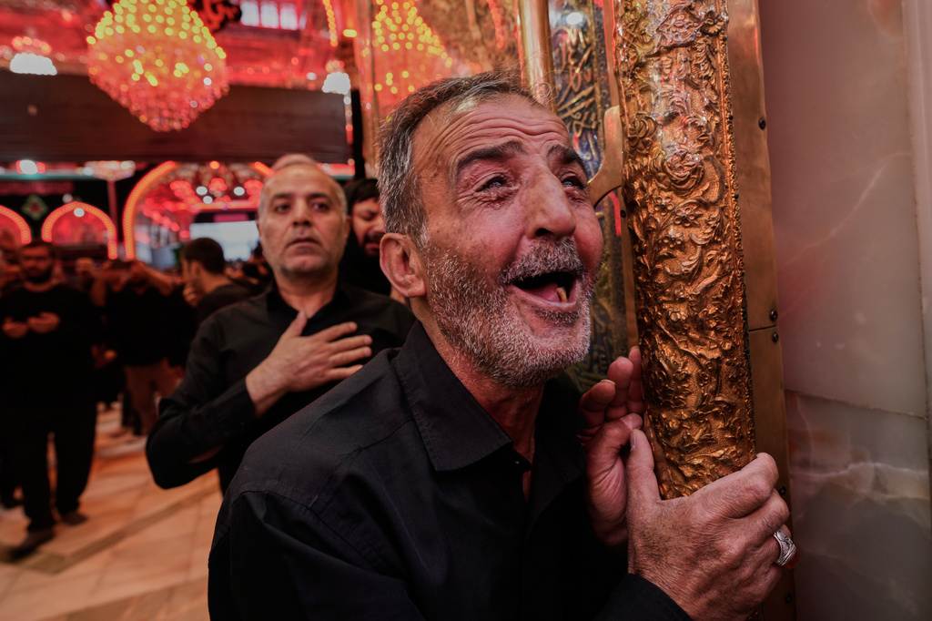 Shiite worshippers visit the holy shrine of Imam Husseinon, during "Muharram," a period of mourning for Shiites in Karbala, Iraq, Wednesday, June 24, 2025. (AP Photo/Hadi Mizban)