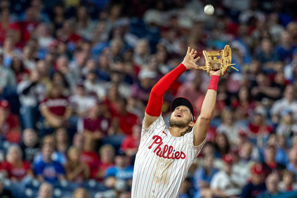 Philadelphia Phillies third baseman Alec Bohm catches a fly ball from Miami Marlins' Javier Sanoja during the eighth inning of a baseball game, Tuesday, Sept. 23, 2025, in Philadelphia. (AP Photo/Laurence Kesterson)