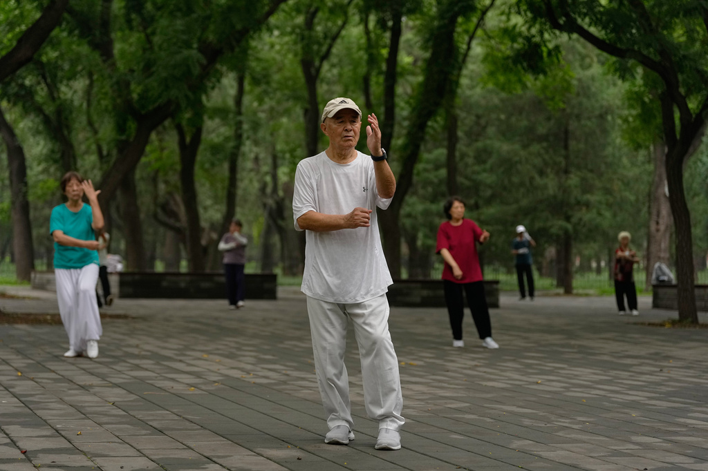 People practice Tai Chi at a park near the Temple of Heaven in Beijing Thursday July 9, 2026. (AP Photo/Andy Wong)