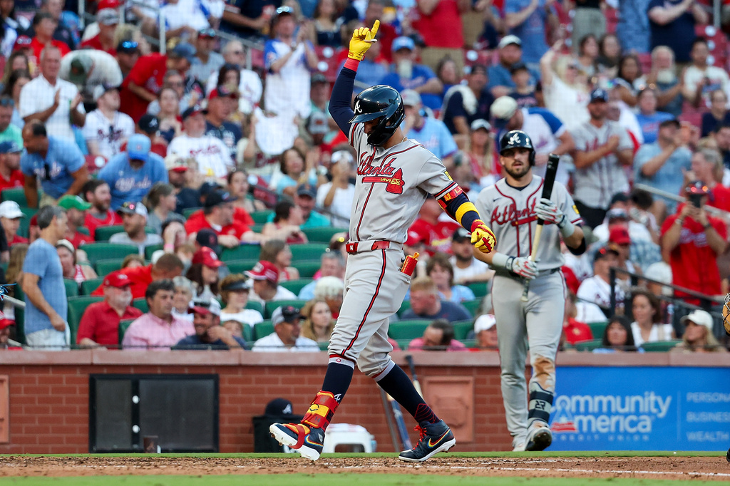 Atlanta Braves' Mauricio Dubón, left, points skyward as he crosses home plate after hitting a solo home run during the seventh inning of a baseball game against the St. Louis Cardinals, Saturday, July 11, 2026, in St. Louis. (AP Photo/Scott Kane)