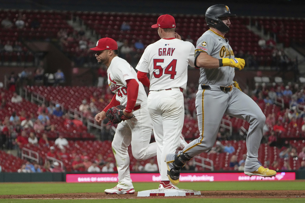 Pittsburgh Pirates' Spencer Horwitz, right, reaches base on a throwing error by St. Louis Cardinals first baseman Willson Contreras, left, as Cardinals starting pitcher Sonny Gray (54) watches during the sixth inning of a baseball game Wednesday, Aug. 27, 2025, in St. Louis. (AP Photo/Jeff Roberson)