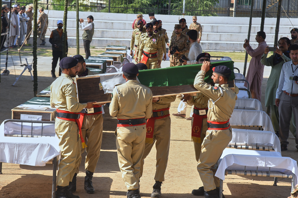 Army soldiers carry a flag-wrapped casket of military personnel, killed in the Wednesday's helicopter crashed, during a funeral prayer, in Muzaffarabad, the capital of Pakistan-administered Kashmir, Thursday, June 11, 2026. (AP Photo/M.D. Mughal)