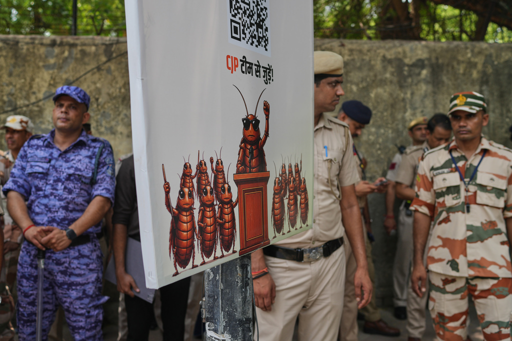 Indian security personnel stand guard during a protest demanding the resignation of Education Minister Dharmendra Pradhan over alleged examination irregularities and repeated paper leaks, in New Delhi, India, Saturday, June 20, 2026. (AP Photo/Manish Swarup)