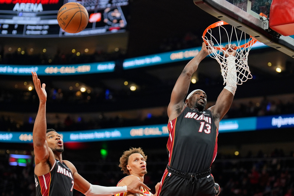 Miami Heat center Bam Adebayo (13) shoots against Atlanta Hawks guard Dyson Daniels (5) during the second half of an NBA basketball game, Wednesday, Oct. 28, 2026, in Atlanta. (AP Photo/Mike Stewart)