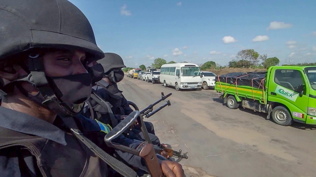 FILE - In this image made from video, Rwandan police patrol a road in Palma, Cabo Delgado province, Mozambique Sunday, Aug. 15, 2021. (AP Photo/Marc Hoogsteyns, File)
