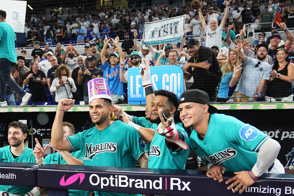 Miami Marlins' Agustín Ramírez, left, celebrates with his teammates after after hitting a walk-off two run home run in the ninth inning to defeat the Los Angeles Dodgers in a baseball game, Sunday, Sept. 13, 2026, in Miami. (AP Photo/Lynne Sladky)