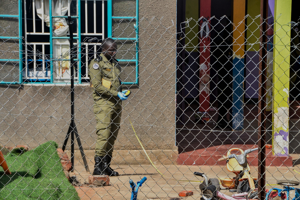 A security personnel secures the crime scene after a man killed four children in a machete attack at the Gaba Early Childhood Development Program nursery school in Kampala, Uganda, Thursday, April 2, 2026. (AP Photo)