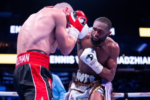 FILE - Jaron Ennis, right, throws a punch at Karen Chukhadzhian, left, during the ninth round IBF World Welterweight title bout, Nov. 9, 2024, in Philadelphia. (AP Photo/Chris Szagola, File) FILE - Jaron Ennis, right, throws a punch at Karen Chukhadzhian, left, during the ninth round IBF World Welterweight title bout, Nov. 9, 2024, in Philadelphia. (AP Photo/Chris Szagola, File)