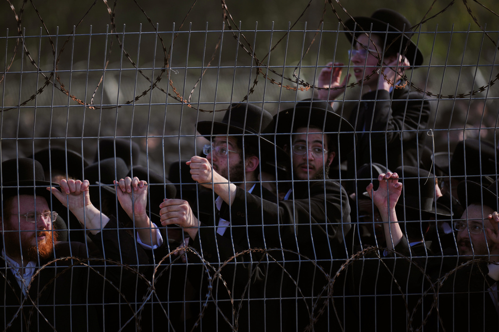 Ultra-Orthodox Jewish men protest against military recruitment and call for the release of detained draft resisters outside a military prison near Kfar Yona, Israel, Wednesday, June 17, 2026. (AP Photo/Ariel Schalit)