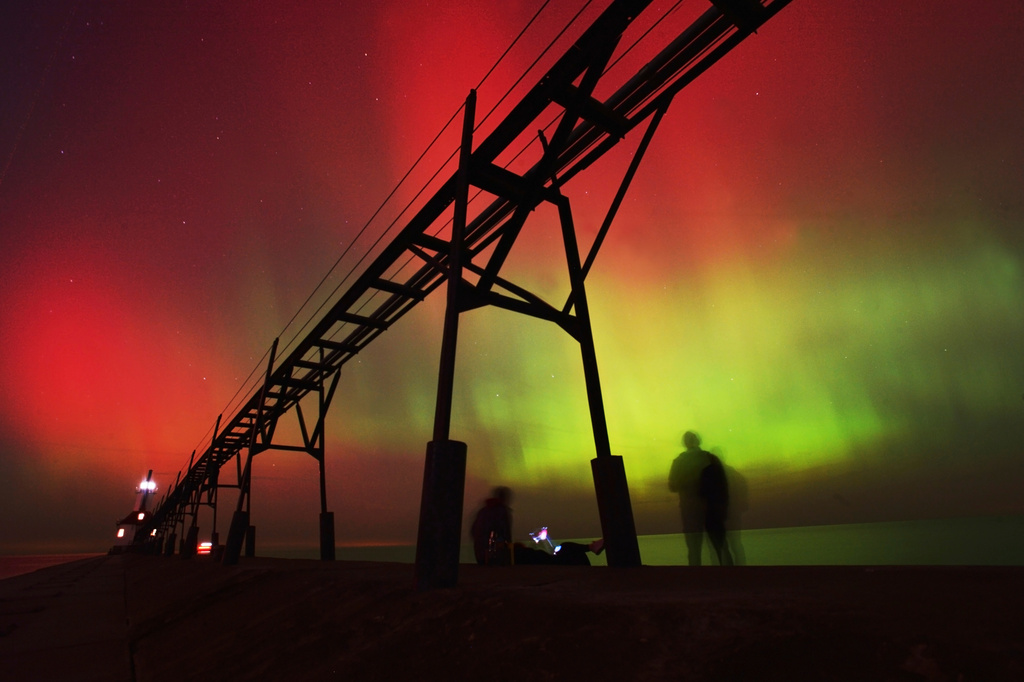 FILE - An aurora borealis, also known as the northern lights, lights up the night sky off Lake Michigan and the St. Joseph Lighthouse, Oct. 10, 2024, in St. Joseph, Mich. (Don Campbell/The Herald-Palladium via AP, File)