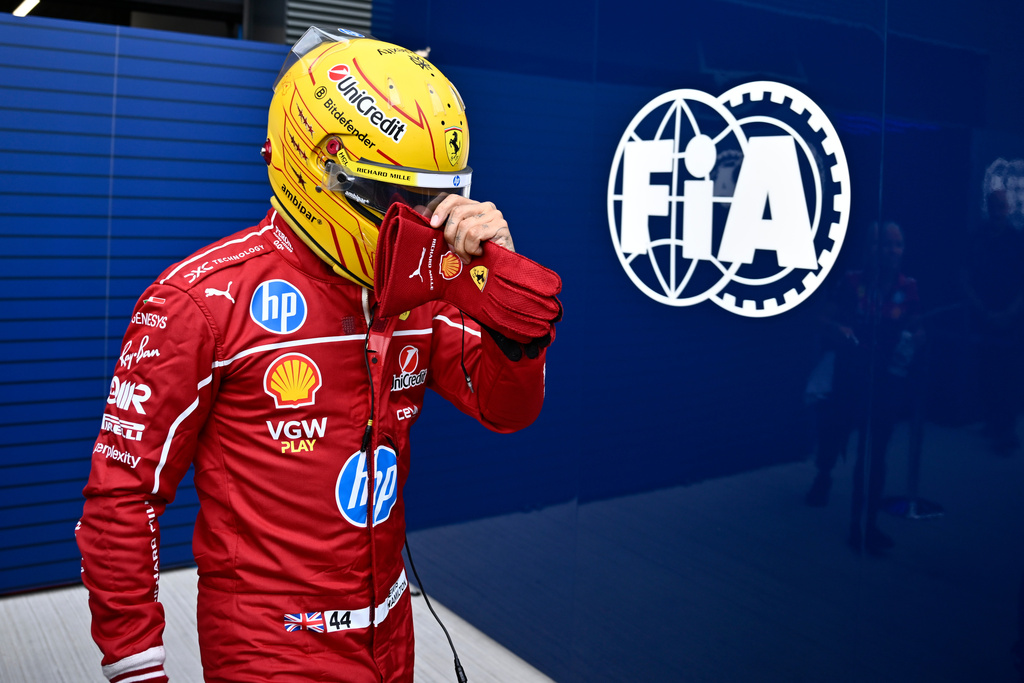 FILE - Ferrari driver Lewis Hamilton of Britain walks back to his pits during the qualifying session for the Hungarian Formula One Grand Prix at the Hungaroring racetrack in Mogyorod, Hungary, Aug. 2, 2025. (AP Photo/Denes Erdos, file)