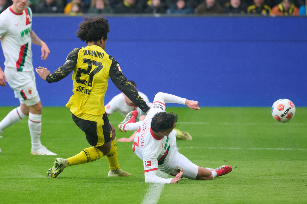 Dortmund's Karim Adeyemi, center left, scores the opening goal during the German Bundesliga soccer match between Borussia Dortmund and FC Augsburg in Dortmund, Germany, Saturday, March 14, 2026. (Bernd Thissen/dpa via AP)
