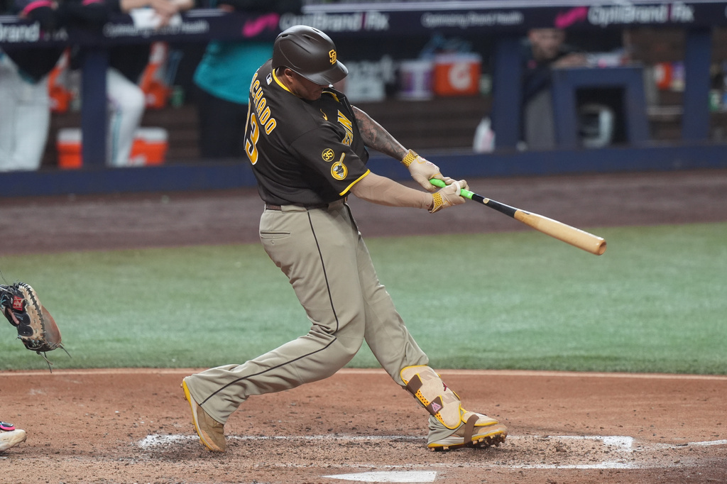 San Diego Padres Manny Machado (13) hits a single during the fifth inning of a baseball game against the Miami Marlins Friday, July 24, 2026, in Miami. (AP Photo/Marta Lavandier)