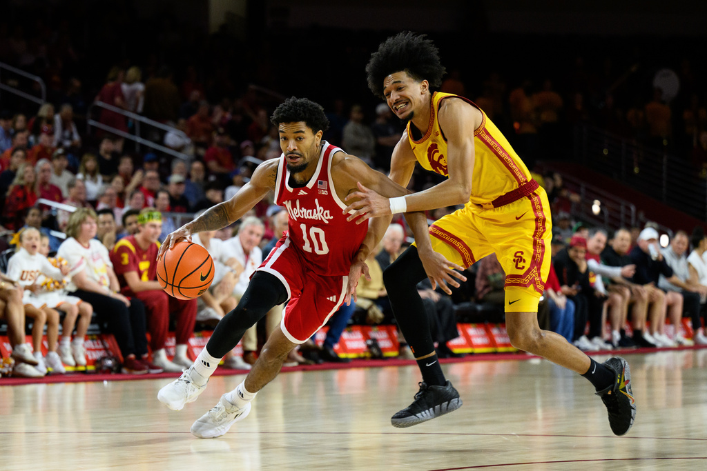 Nebraska guard Jamarques Lawrence (10) drives with the ball past Southern California forward Chad Baker-Mazara, right, during the first half of an NCAA college basketball game Saturday, Feb. 28, 2026, in Los Angeles. (AP Photo/William Liang)