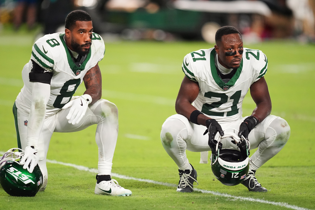 New York Jets' Andre Cisco (8) and Brandon Stephens (21) look on as Miami Dolphins' Tyreek Hill is taken off the field after suffering an unknown injury in the second half of an NFL football game, Monday, Sept. 29, 2025, in Miami Gardens, Fla. (AP Photo/Rebecca Blackwell)