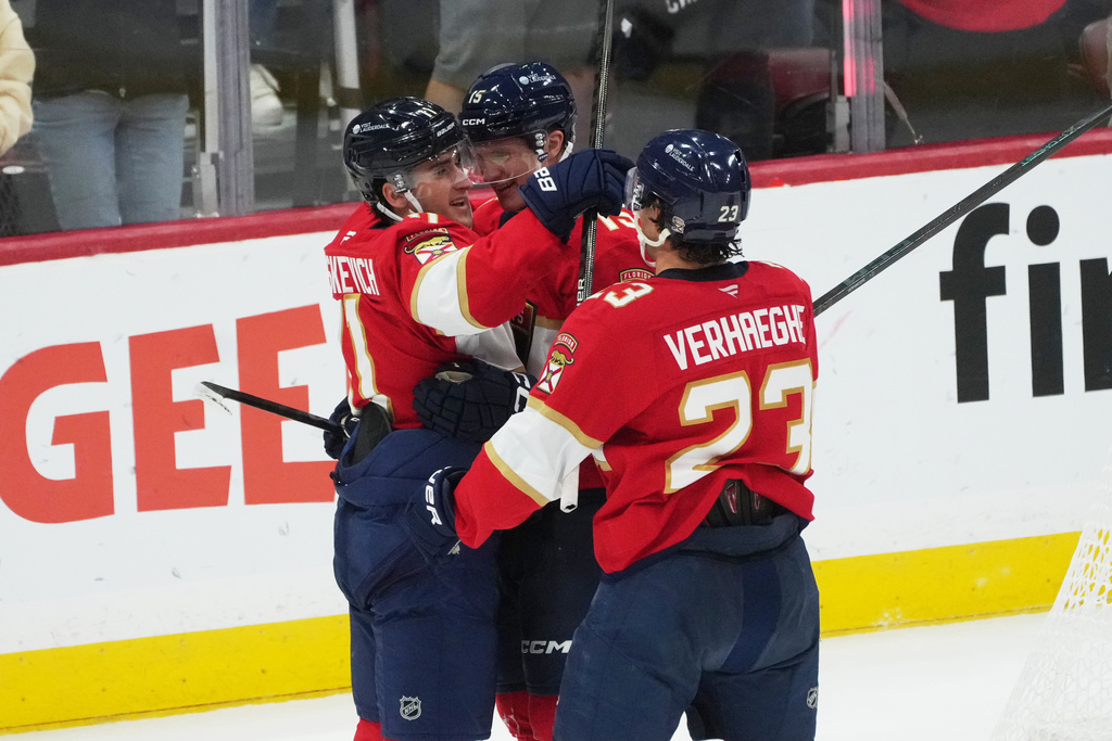 Florida Panthers right wing Mackie Samoskevich (11) celebrates his goal with teammates during the third period of an NHL hockey game against the Ottawa Senators, Saturday, Oct. 11, 2025, in Sunrise, Fla. (AP Photo/Marta Lavandier)