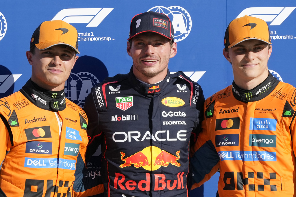 Red Bull driver Max Verstappen of the Netherlands, centre, celebrates his pole position with McLaren driver Lando Norris of Britain, left, and McLaren driver Oscar Piastri of Australia after the qualifying session ahead of the Italian Grand Prix at the Monza racetrack in Monza, Italy, Saturday, Sept. 6, 2025. (AP Photo/Luca Bruno)