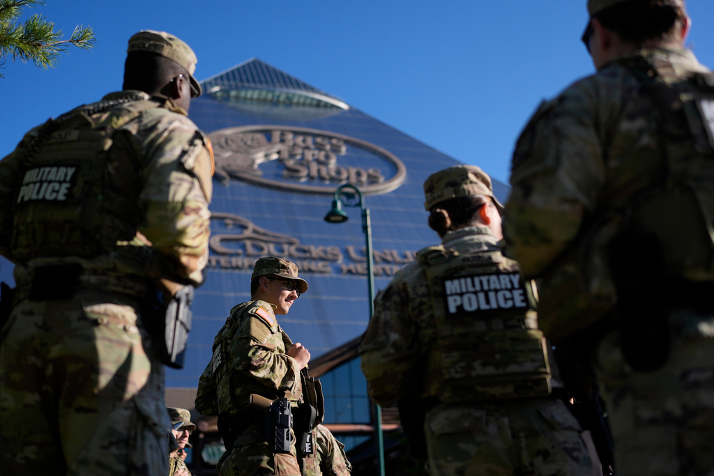 Members of National Guard patrol outside a Bass Pro Shops, Friday, Oct. 10, 2025, in Memphis, Tenn. (AP Photo/George Walker IV)