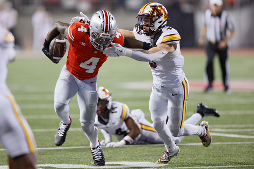 Ohio State receiver Jeremiah Smith, left, stiff arms Minnesota defensive back Koi Perich during the first half of an NCAA college football game Saturday, Oct. 4, 2025, in Columbus, Ohio. (AP Photo/Jay LaPrete) Ohio State receiver Jeremiah Smith, left, stiff arms Minnesota defensive back Koi Perich during the first half of an NCAA college football game Saturday, Oct. 4, 2025, in Columbus, Ohio. (AP Photo/Jay LaPrete)