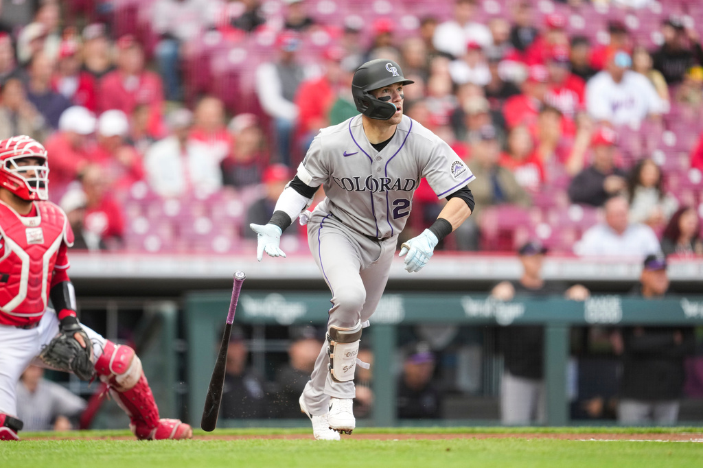 Colorado Rockies' Brett Sullivan (26) watches his two-run double during the first inning of a baseball game against the Cincinnati Reds, Wednesday, April 29, 2026, in Cincinnati. (AP Photo/Jeff Dean)