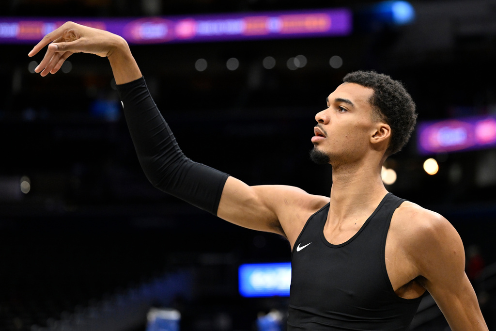 San Antonio Spurs forward Victor Wembanyama warms up before an NBA basketball game against the Washington Wizards, Sunday, Dec. 21, 2025, in Washington. (AP Photo/John McDonnell)