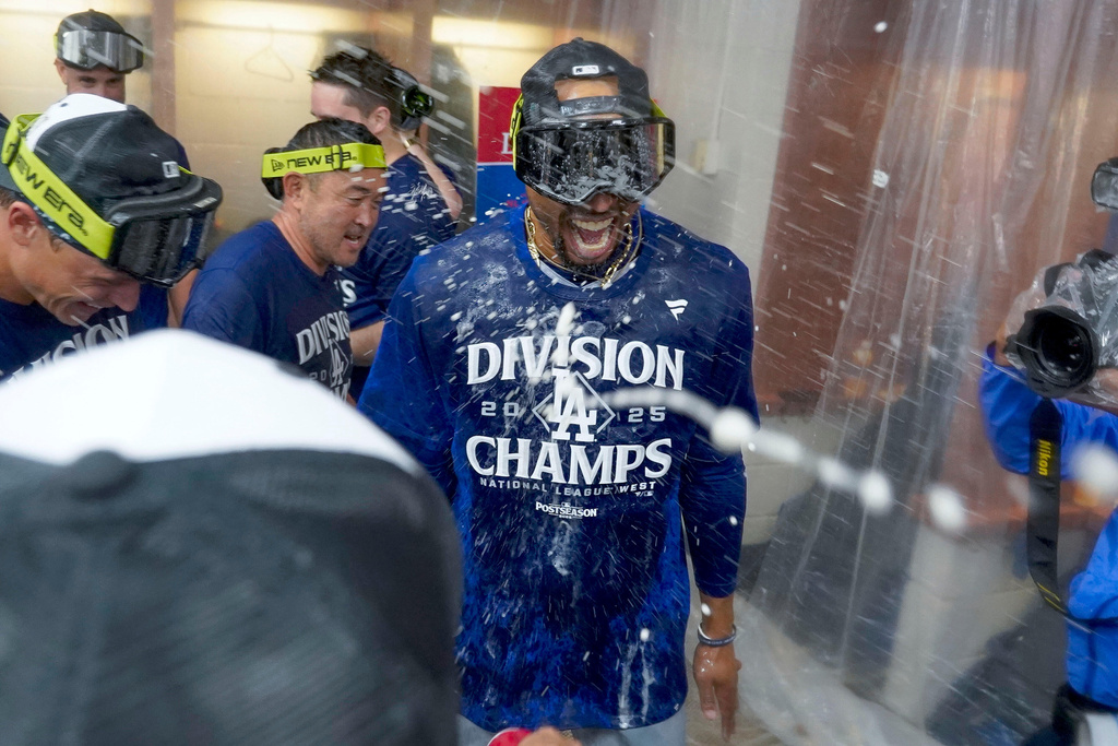 Los Angeles Dodgers shortstop Mookie Betts celebrates after the Dodgers clinched the National League West title against the Arizona Diamondbacks during a baseball game at Chase Field Thursday, Sept. 25, 2025, in Phoenix. (AP Photo/Darryl Webb)