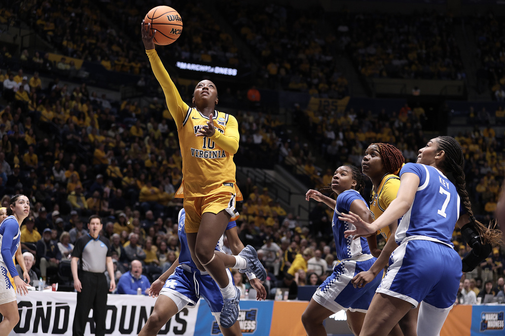 West Virginia guard Jordan Harrison (10) shoots against Kentucky in the first half in the second round of the NCAA college basketball tournament, Monday, March 23, 2026, in Morgantown, W.Va. (AP Photo/Kathleen Batten)