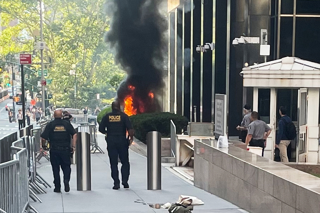 This photo provided by Robert Sullivan shows black smoke and flames in front of 26 Federal Plaza in lower Manhattan, Monday, July 20, 2026, in New York. (Robert Sullivan via AP)