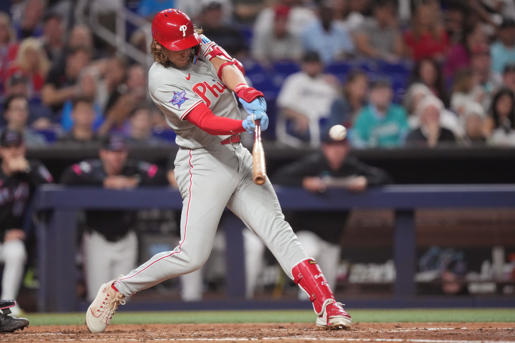 Philadelphia Phillies third baseman Alec Bohm (28) hits a single and drives in a run against the Miami Marlins during the fourth inning of a baseball game, Friday, May 1, 2026, in Miami. (AP Photo/Jim Rassol)