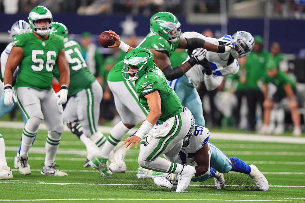 Philadelphia Eagles quarterback Jalen Hurts (1) his sacked by Dallas Cowboys defensive tackle Osa Odighizuwa (97) during the second half of an NFL football game Sunday, Nov. 23, 2025, in Arlington, Texas. (AP Photo/LM Otero)