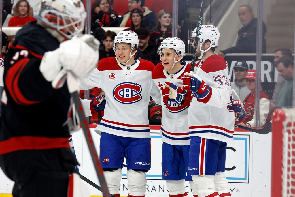 Montréal Canadiens' Oliver Kapanen (91), Ivan Demidov, center, and Noah Dobson (53) celebrate a goal by Sammy Blais, not shown, against the Carolina Hurricanes during the first period of an NHL hockey game in Raleigh, N.C., Thursday, Jan. 1, 2026. (AP Photo/Karl DeBlaker)
