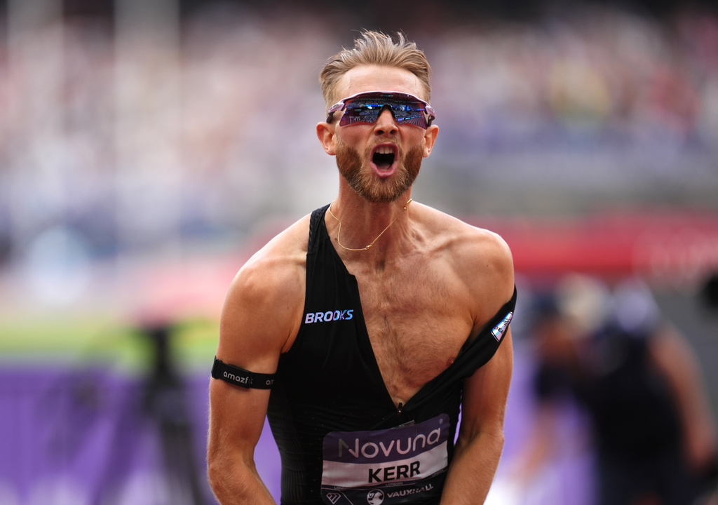 Britain's Josh Kerr celebrates after winning and breaking a world record in the Men's 1 Mile final during the Novuna London Athletics Meet at the London Stadium, Saturday July 18, 2026. (Adam Davy/PA via AP)