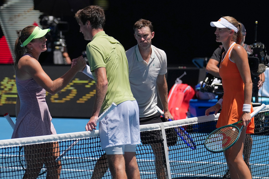 Australia's Olivia Gadecki, left, and John Peers, second right, are congratulated by France's Kristina Mladenovic, right, and Manuel Guinard, second left, after winning the mixed doubles final at the Australian Open tennis championship in Melbourne, Australia, Friday, Jan. 30, 2026. (AP Photo/Dita Alangkara)