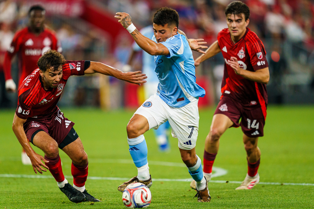 New York City FC's Nicolas Fernandez (7) dribbles past Toronto FC's Kobe Franklin (left) during the first half of an MLS soccer match in Toronto, Saturday, Aug. 29, 2026. (Keito Newman/The Canadian Press via AP)