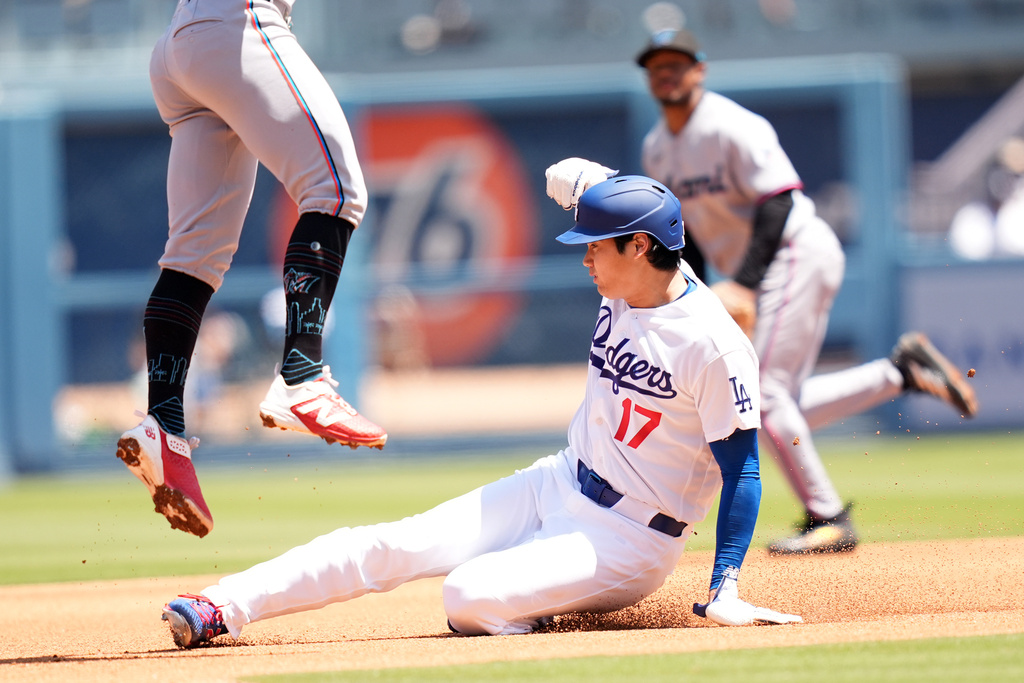 Los Angeles Dodgers' Shohei Ohtani (17) steals second base as Miami Marlins' Otto Lopez leaps for the throw in the third inning of a baseball game Wednesday, April 29, 2026, in Los Angeles. (AP Photo/Scott Strazzante)