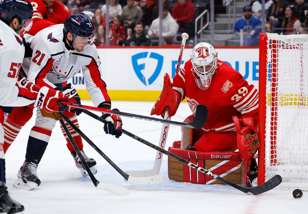 Washington Capitals center Aliaksei Protas (21) can't score against Detroit Red Wings goaltender Cam Talbot (39) during the second period of an NHL hockey game Sunday, Dec. 21, 2025, in Detroit. (AP Photo/Duane Burleson)