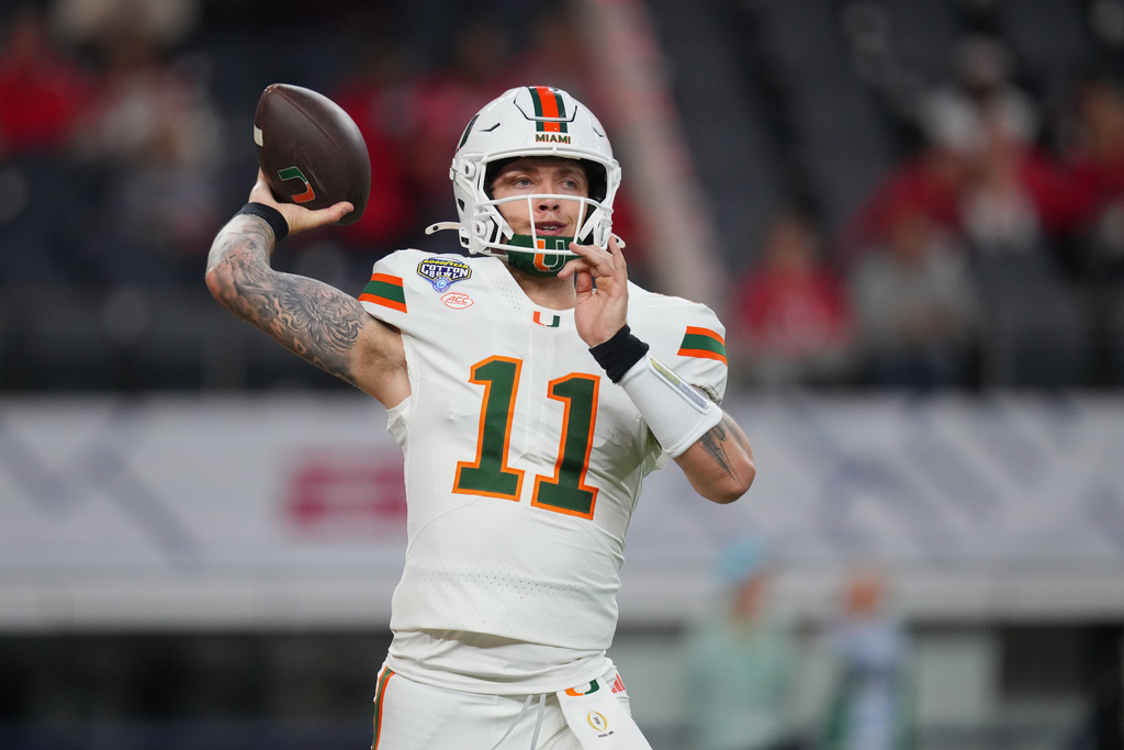 Miami quarterback Carson Beck works out prior to the Cotton Bowl College Football Playoff quarterfinal game against Ohio State Wednesday, Dec. 31, 2025, in Arlington, Texas. (AP Photo/Julio Cortez)