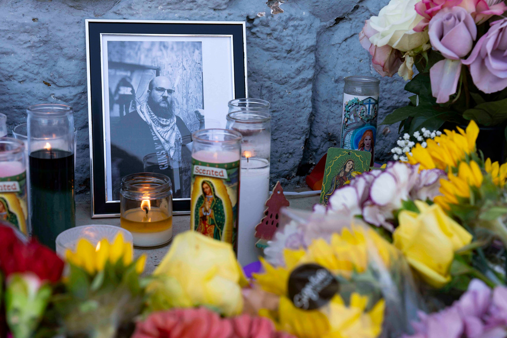 A growing memorial sits outside the Venture-N Bar in Tucson, Ariz., Tuesday, Sept. 1, 2026, for Cameron Capara, pictured, and Vincent Siquieros, who were fatally shot in the parking lot of the gay bar shortly after midnight Monday. (AP Photo/Rebecca Noble)