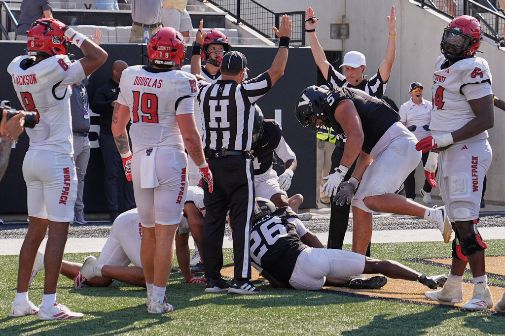 Officials signal touchdown after Vanderbilt cornerback Cayden Daniels (26) recovered a North Carolina State fumble in the end zone during the second half of an NCAA college football game Saturday, Sept. 19, 2026, in Nashville, Tenn. (AP Photo/George Walker IV)