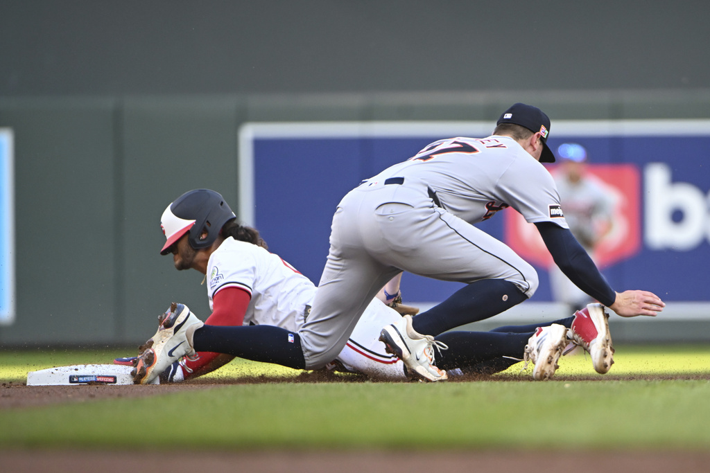 Detroit Tigers shortstop Trey Sweeney, right, tags out Minnesota Twins' Austin Martin, left, who was trying to steal second base during the first inning of a baseball game Saturday, Aug. 16, 2025, in Minneapolis. (AP Photo/Craig Lassig)