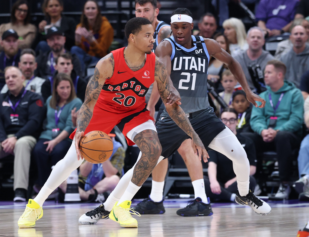 Toronto Raptors guard Markelle Fultz (20) dribbles against Utah Jazz guard Bez Mbeng (21) during the first half of an NBA basketball game, Monday, March 23, 2026, in Salt Lake City. (AP Photo/Rob Gray)