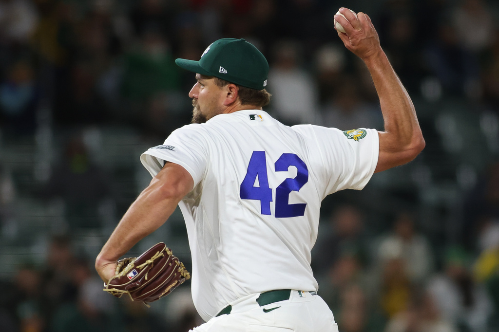 Athletics pitcher Joel Kuhnel throws to a Texas Rangers batter during the ninth inning of a baseball game Wednesday, April 15, 2026, in West Sacramento, Calif. (AP Photo/Scott Marshall)