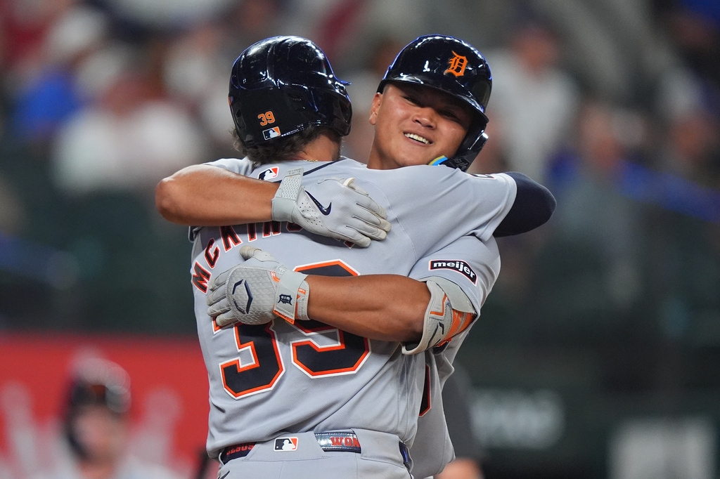 Detroit Tigers' Zach McKinstry (39) hugs teammate Hao-Yu Lee after scoring on a home run by Lee during the fifth inning of a baseball game against the Texas Rangers, Thursday, July 2, 2026, in Arlington, Texas. (AP Photo/LM Otero)