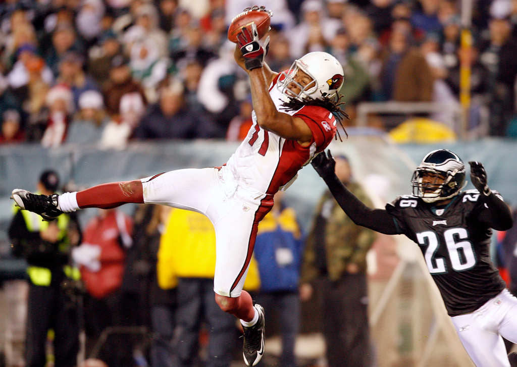 FILE - Arizona Cardinals wide receiver Larry Fitzgerald catches a pass in front of Philadelphia Eagles cornerback Lito Sheppard in the fourth quarter of an NFL football game in Philadelphia, Nov. 27, 2008. (AP Photo/Tom Mihalek, File)