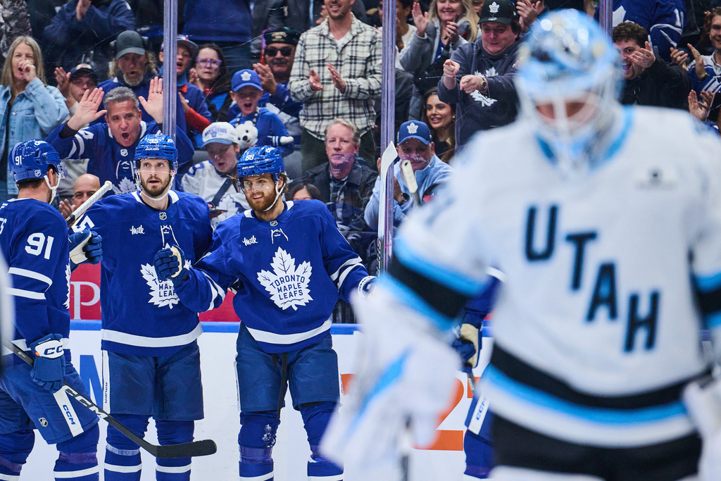 Toronto Maple Leafs' William Nylander (right) celebrates with his team after scoring against the Utah Mammoth during second period NHL hockey action in Toronto, on Wednesday, Nov. 5, 2025. (Sammy Kogan/The Canadian Press via AP)